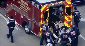  ??  ?? Injured: A victim on stretcher is put in an ambulance at the school yesterday