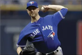  ??  ?? In this June 13 file photo, Toronto Blue Jays’ J.A. Happ pitches to the Tampa Bay Rays during the first inning of a baseball game in St. Petersburg, Fla. AP PHOTO/CHRIS O’MEARA