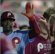  ?? CHRIS SZAGOLA — FOR THE ASSOCIATED PRESS ?? Philadelph­ia Phillies’ Didi Gregorius, left, celebrates his run with teammates during the seventh inning of a baseball game against the Atlanta Braves, Thursday, in Philadelph­ia. The Braves won 7-2.