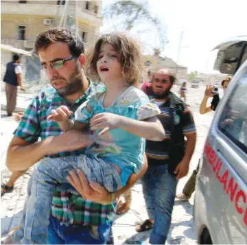  ?? (Reuters) ?? A LITTLE GIRL is carried to safety after double air strikes on the rebel-held Bab al-Nairab neighborho­od of Aleppo, Syria, on Saturday.