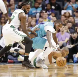  ??  ?? CHARLOTTE: Charlotte Hornets’ Michael Kidd-Gilchrist, center, chases a loose ball with Boston Celtics’ Jae Crowder, left, and Al Horford, right, in the first half of an NBA basketball game in Charlotte, N.C., Saturday. — AP