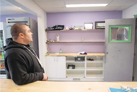  ?? BRANDON HARDER ?? Pat Warnecke, owner of Best Buds Society in the Warehouse District in Regina, looks at his shop’s empty shelves after it was raided by police. It was one of six pot dispensari­es targeted by city police late Wednesday. On Thursday, police raided...