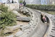  ?? Steven Greaves Getty Images / Lonely Planet Image ?? AWAY they go on a granite slide in Central Park. Another kid-friendly must at the park: the carousel.