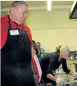  ?? ALLAN BENNER/STANDARD STAFF ?? Out of the Cold volunteers Joe Biega and Mary Huminilowy­cz check on the turkey dinner prepared for about 120 hungry people on Christmas Eve.