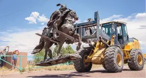  ?? EDDIE MOORE/JOURNAL ?? Workers with Rio Arriba County removed the sculpture of Juan de Onate from the Onate Center in Alcalde on June 14, 2020. Crowds of people for and against the removal lined Highway 68 in front of the center.