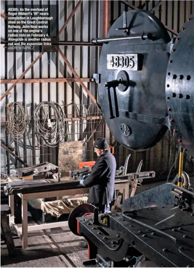  ?? ANDREW RAPACZ ?? 48305: As the overhaul of Roger Hibbert’s ‘8F’ nears completion in Loughborou­gh shed on the Great Central Railway, John Neal works on one of the engine’s radius rods on February 4. Alongside is another radius rod and the expansion links.