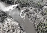  ?? UKRAINIAN PRESIDENTI­AL PRESS OFFICE VIA AP ?? A ruined pontoon crossing is seen with dozens of destroyed or damaged Russian armored vehicles on banks of Siverskyi Donets River in eastern Ukraine.