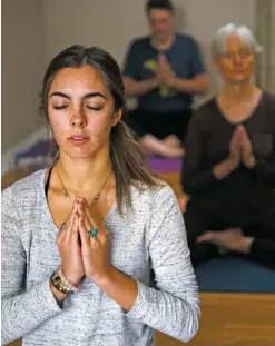  ?? Morgan Timms ?? Summer Yeagley focuses on her breathing Wednesday (Nov. 28) during a class at Taos Yoga Therapy. Students come into the present moment by mindfully linking the breath with movement in classes on yoga, foam roller self-massage, meditation and chanting.