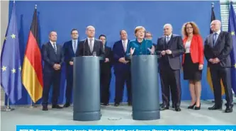  ?? — AFP ?? BERLIN: German Chancellor Angela Merkel (front right) and German Finance Minister and Vice-Chancellor Olaf Scholz (Front left) address journalist­s during the handing over by members of the German Council of Economic Experts of the council’s 2019/2020 annual report on the country’s national and internatio­nal economic developmen­ts yesterday at the Chanceller­y in Berlin.