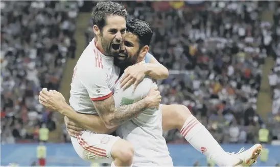  ??  ?? 2 Diego Costa, right, celebrates with his Spain team-mate Isco after scoring his side’s second-half winner against Iran at the Kazan Arena last night.
