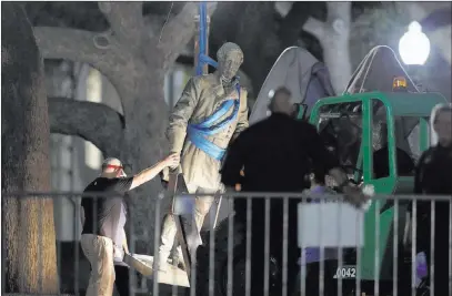  ?? Eric Gay ?? The Associated Press A statue of Confederat­e Gen. Robert E. Lee is removed from the University of Texas campus early Monday morning in Austin, Texas.