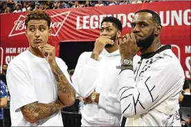  ?? ETHAN MILLER / GETTY IMAGES ?? Kyle Kuzma (left), Anthony Davis and LeBron James of the Los Angeles Lakers talk before a game between the Lakers and Clippers during the NBA Summer League in Las Vegas. They were on hand to watch the young players.