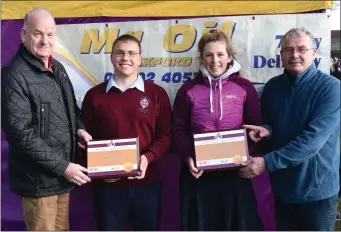  ??  ?? Pádraig Hore and Marguerite Furlong receiving their Mr Oil athlete of the month awards.