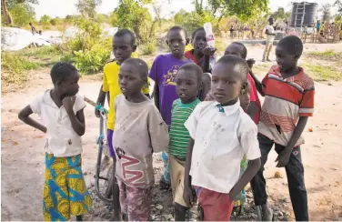  ?? Adelle Kalakouti / Associated Press ?? South Sudanese refugee children gather in the Rhino settlement camp near Arua in northern Uganda.