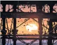  ??  ?? Thousands of starlings roost under the pier at Aberystwyt­h as the winter sun sets