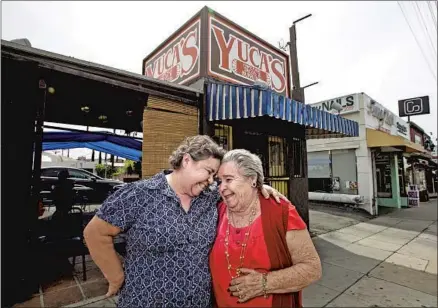  ?? Brian van der Brug Los Angeles Times ?? DORA HERRERA, left, and her mother, Soccoro, at Yuca’s Tacos in Los Feliz in 2016. Yuca’s found ways to survive the shutdowns.