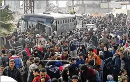  ?? SANA VIA AP ?? Syrian civilians flee fighting between Syrian government forces and rebels in eastern Ghouta, a suburb of Damascus, Syria, this month. A government assault sparked a tide of people trying to escape the violence. Some moved deeper into the rebel-held...