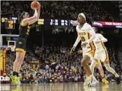  ?? ABBIE PARR / AP ?? Iowa guard Caitlin Clark shoots against Minnesota guard Janay Sanders (front) and guard Amaya Battle on Wednesday in Minneapoli­s. If Clark scores more than 17 points today against Ohio State, she will surpass Pete Maravich’s college career points mark.