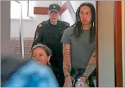  ?? AP PHOTO BY ALEXANDER ZEMLIANICH­ENKO ?? WNBA star and two-time Olympic gold medalist Brittney Griner is escorted to a courtroom for a hearing, in Khimki just outside Moscow, Russia, Monday, June 27, 2022.