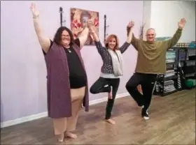  ?? JEAN BONCHAK — THE NEWS-HERALD ?? From left, Jaimee Bruening, Christine Sustar and Mark Mazanec demonstrat­e the Tree Pose at The Calming Tree yoga studio in Mentor.