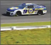  ?? Associated Press ?? Chase Elliott drives through Turn 1 during the NASCAR Cup Series auto race at Pocono Raceway, Sunday, in Long Pond, Pa. Elliott finished third, but was awarded first after Denny Hamlin and Kyle Busch were disqualifi­ed.