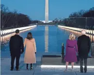  ?? EVAN VUCCI/AP ?? Vice President-elect Kamala Harris and her husband, Doug Emhoff, join President-elect Joe Biden and his wife, Jill, at a COVID-19 memorial event at the Lincoln Memorial Reflecting Pool in Washington on Tuesday.