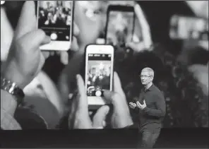 ?? AP ?? Apple Inc. CEO Tim Cook describes the functions of the iPhone 7 during a product release event in this September, 2016 photo. Two Apple-focused blogs said over the weekend that Apple will release three phones today: the iPhone 8, iPhone 8 Plus and...