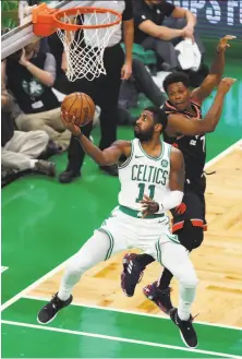  ?? Tim Bradbury / Getty Images ?? Kyrie Irving made or assisted on every Celtics basket in overtime as Boston defeated Toronto 123-116.