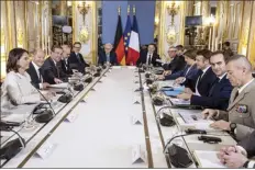  ?? Christophe Petit Tesson, Pool photo via AP ?? German Foreign Affairs Minister Annalena Baerbock (from left) German Chancellor Olaf Scholz, German Defense Minister Boris Pistorius, French Defense Minister Sebastien Lecornu (second from right) and French President Emmanuel Macron (third from right) attend a Defense and Security joint council upon a Franco-German Ministers council as part of the 60th anniversar­y of the Elysee Treaty at Elysee Palace in Paris on Sunday.