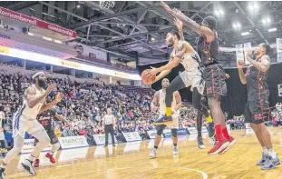  ?? JEFF PARSONS/ST. JOHN’S EDGE ?? Isaiah Tate of the St. John’s Edge pulls down a rebound in front of Windsor Express players Anthony Ottley (21) and Angelo Griffis (32) as Edge teammate Obinna Oleka calls for the ball during an NBL Canada game Sunday at Mile One Centre. The Edge took a pair of games off the Express over the weekend.