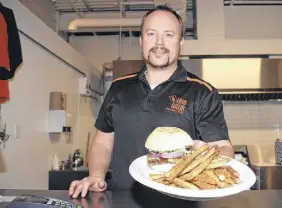  ?? HARRY SULLIVAN – TRURO NEWS ?? Trevor Macdonald of Grub Hub on Inglis Place shows a sample of his smoking gouda burger and fries that he will be doing as his signature offering for Burger Week.