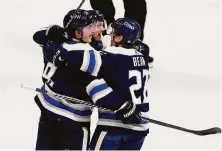  ?? Paul Vernon / Associated Press ?? The Blue Jackets celebrate after Zach Werenski (left) scored to put Columbus ahead 4-3 in the third period against Detroit.