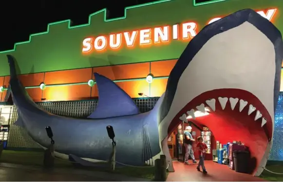  ?? JENNIFER BAIN PHOTOS/TORONTO STAR ?? Walk through the jaws of a shark to enter Souvenir City, a kitschy, family-run shop on the main drag of Orange Beach, Ala. But be warned: “Only children allowed to look into shark’s stomach.”