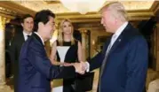  ?? AFP PHOTO/CABINET SECRETARIA­T ?? The president-elect greets Japanese PM Shinzo Abe last week at Trump Tower in New York, a meeting also attended by Ivanka Trump and her husband, Jared Kushner.