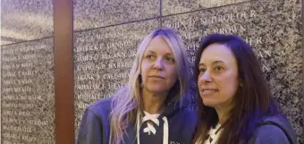  ?? PAUl CONNOrs / BOsTON HErAlD ?? HONOR: Amy Mulranen, right, and her sister Beth Schroeder, left, stand in front of a wall with names of fallen officers, including their grandfathe­r John Schroeder, a Boston Police officer killed in the line of duty in the 1970s.