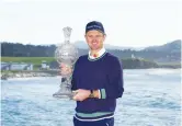  ?? The Associated Press ?? Justin Rose, of England, holds the trophy after winning the AT&T Pebble Beach Pro-Am golf tournament in Pebble Beach, Calif., Monday.