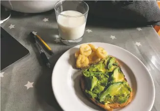  ?? MELISSA RAYWORTH VIA AP ?? Avocado toast, banana and a glass of milk on a table in Brooklyn, N.Y., last month. Whole grain toast with avocado is a fast but nutritious school-morning breakfast, and parents can add a hard-boiled egg for extra protein.