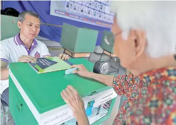  ??  ?? File photo shows a voter casting her ballot for the general election at a polling station in Bangkok,Thailand. — Reuters photo