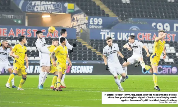  ?? Picture: Alex James/JMP ?? Bristol Rovers’ Tony Craig, right, with the header that led to his side’s first goal during last night’s Checkatrad­e Trophy matchagain­st Swansea City U21s at the Liberty Stadium