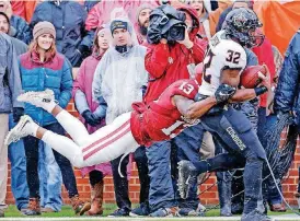  ?? [PHOTO BY STEVE SISNEY, THE OKLAHOMAN] ?? Senior safety Ahmad Thomas (13) had a dip in production in 2016. The Miami, Fla. native finished the regular season without an intercepti­on after producing three the year before.