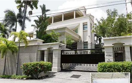  ??  ?? Luxurious abode: The three-storey bungalow in Tanjung Bungah Park owned by fugitive businessma­n Low Taek Jho’s family. (Inset) A copy of the notice from Bukit Aman pasted outside the bungalow.