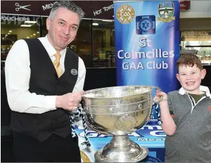  ??  ?? Tosh and Jack Barry with the Sam Maguire cup when it visited Southgate Shopping Centre with St Colmcilles GFC