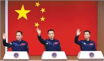  ?? WANG JIANGBO / FOR CHINA DAILY ?? Members of the Shenzhou XV space mission — Fei Junlong (center), Deng Qingming (right) and Zhang Lu — meet the media on Monday during a news conference at the Jiuquan Satellite Launch Center in Northwest China.