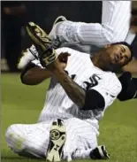  ?? DAVID BANKS, THE ASSOCIATED PRESS ?? White Sox second baseman Yoan Moncada and right-fielder Willy Garcia, bottom, collide on a double hit by Toronto Blue Jays’ Darwin Barney on Monday night in Chicago. For the result of Tuesday night’s game between the same two teams, see thespec.com.