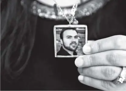  ??  ?? Naghmeh Abedini in June holds a necklace with a photograph of her husband, Saeed, a pastor. Iran state TV reported that the government has released several prisoners. The Associated Press has confirmed that among them are the pastor, Washington Post...