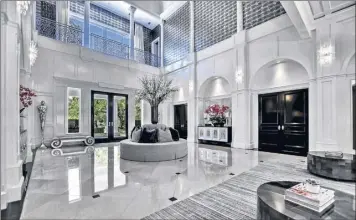  ?? Susan Carnes / fast Pix tours / tns ?? Hall of fame baseball player roberto Alomar sold his 18,700-square-foot home in tampa for $4 million. dramatic in style, the multilevel residence features two kitchens, paneled walls and eye-catching chandelier­s. the office / den is enclosed in glass.