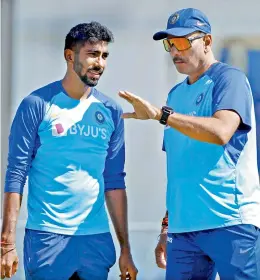  ?? — BCCI ?? Top: Jasprit Bumrah is all ears to India coach Ravi Shastri during a training session.