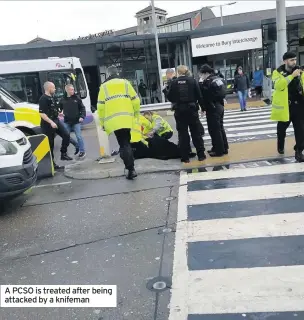  ??  ?? A PCSO is treated after being attacked by a knifeman