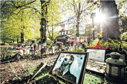  ??  ?? The makeshift shrine to George Michael has become untidy, with wilting flowers and turf that has turned to mud. The family has asked that it be dismantled