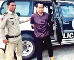  ?? SUPPLIED ?? Former Khmer Power Party President Sourn Serey Ratha, seen in handcuffs, gets out of a police vehicle following his arrest in August 2017.